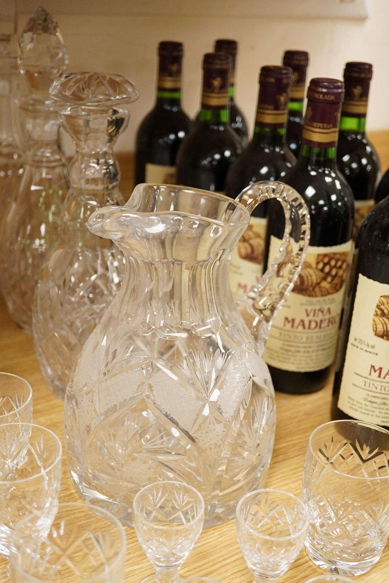 A collection of Webb cut glass suites and four decanters, together with a glass jug, largest 35cm high